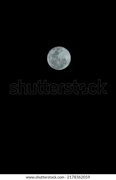 A super\
moon in the dark sky. Bright moon.\
Nature.