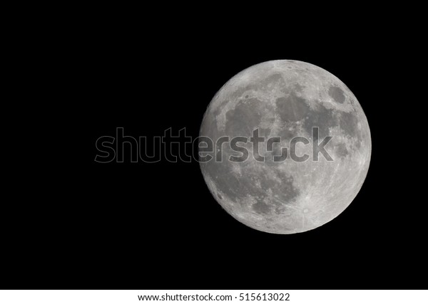Super moon. The moon is full (or nearly full).\
Craters and mountains are clearly visible at the edges. There is\
room for text to the\
left.