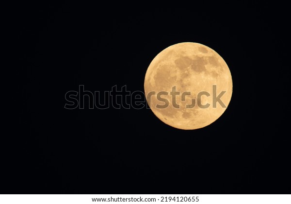 Super\
moon, full, in the starry sky. Natural\
background.