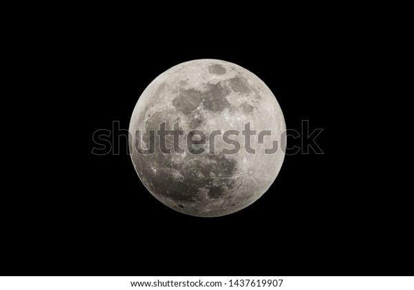 Super\
moon as a lunar eclipse begins to cover the\
moon.