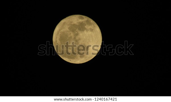 Super moon over dark black sky at night\
taken. Full moon\
background.
