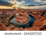 Super panorama of Horseshoe Bend in Page Arizona at sunset, showing a dramatic sky and the horseshoe shape from which the Colorado River flows.