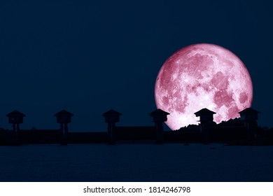 Super pink moon and silhouette dam in the night sky, Elements of this image furnished by NASA