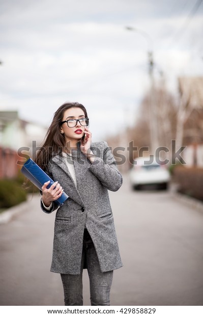 Super
professional saleswoman, people concept - happy businesswoman with
folder and mobile phone over property
background