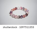 Super seven beautiful and lucky stone bracelet on white background. The stones contain Amethyst,  Clear Quartz, Smoky Quartz,  Cacoxenite,  Rutile,  Geothite  and Lepidocrocite.
