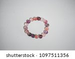 Super seven beautiful and lucky stone bracelet on white background. The stones contain Amethyst,  Clear Quartz, Smoky Quartz,  Cacoxenite,  Rutile,  Geothite  and Lepidocrocite.
