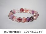 Super seven beautiful and lucky stone bracelet on white background. The stones contain Amethyst,  Clear Quartz, Smoky Quartz,  Cacoxenite,  Rutile,  Geothite  and Lepidocrocite.