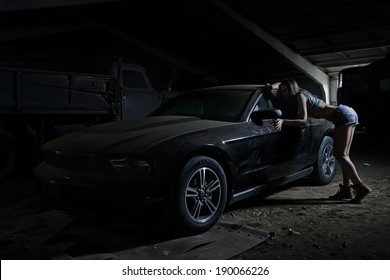 Super Sexy Chick With Old Muscle American Black Car In Dusty Garage