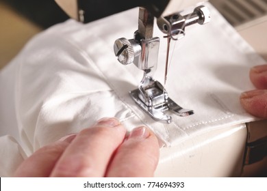 Super Slow Motion Of A Professional Sewing Machine Stitching With White Thread An Italian Haute Couture Fabric, The Seamstress Sews A High Fashion Outfit. Concept Of Industry, Tradition, Fashion