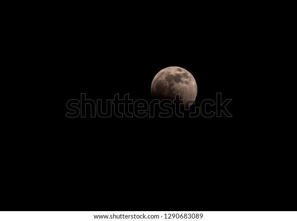 Super wolf moon lunar eclipse as it\
started, before the blood red color shows, January\
2019