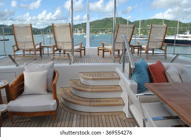 Super Yacht Aft Deck With Lounge Chairs And View Of Antigua Harbor, Caribbean