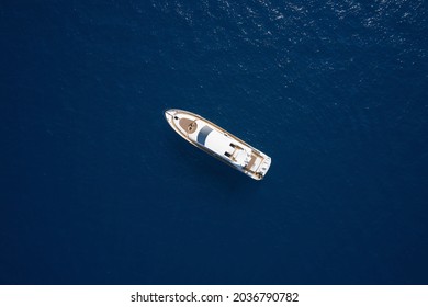 Super Yacht On Blue Water Top View. Huge White Super Mega Yacht On Blue Water In Italy. White Sport Yacht Open Sea Aerial View.