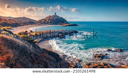 Superb sunrise on popular tourist destination - Acropoli di Bithia with Torre di Chia tower on background. Spectacular morning view of Sardinia island, Italy, Europe. Traveling concept background