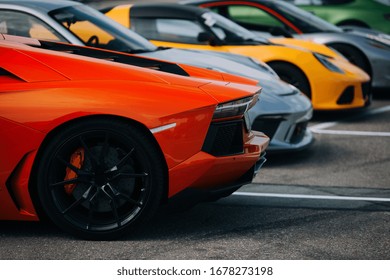 Supercars at the parking lot. Track day at the race track. Fast cars prepared for ride at the raceway. Cars and coffee meet 