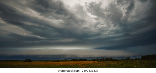 Supercell cloud with distant lightning illuminating the storm structure