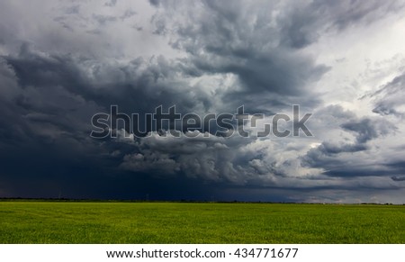 Supercell storm clouds above meadow with green grass
Summer Storm clouds above meadow with green grass
Rising Thunderstorm, Dramatic sky before storm. Dark clouds