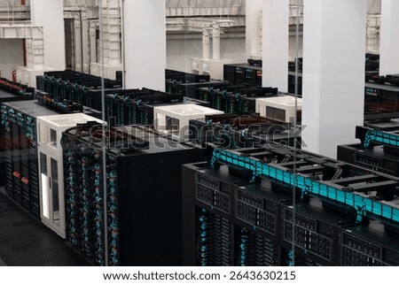 Supercomputer infrastructure inside modern data center with powerful server racks, cooling systems, and high-speed cabling.