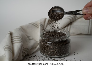 Superfood Chia Seeds Falling On White Background. Super Food Concept