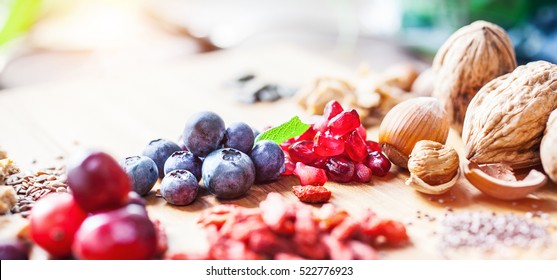 Superfood: Spoons of various healthy superfoods on wooden background