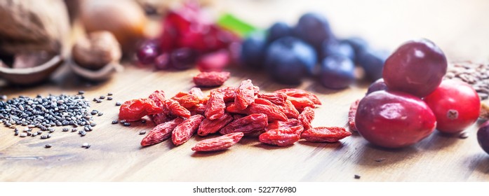 Superfood: Spoons Of Various Healthy Superfoods On Wooden Background