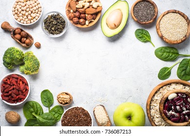 Superfoods On A Gray Background With Copy Space. Nuts, Beans, Greens, Fruit And Seeds. Healthy Vegan Food.