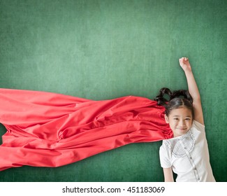 Superhero Asian school girl kid student with inspiration in women rights in education success concept