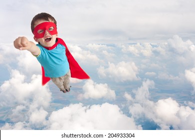 superhero boy child flying mid air above cloud level - Powered by Shutterstock