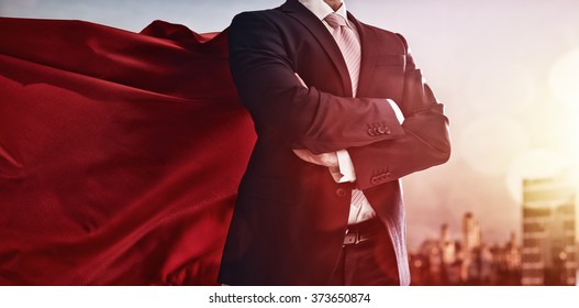 superhero businessman looking at city skyline at sunset. the concept of success, leadership and victory in business. - Shutterstock ID 373650874