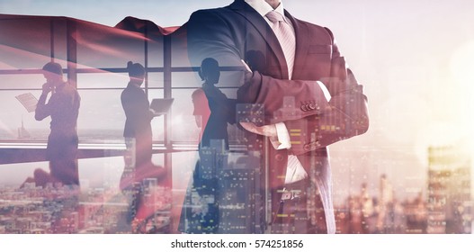 superhero businessman looking at city skyline at sunset. the concept of success, leadership and victory in business.