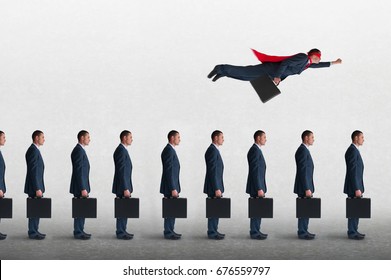 superhero businessman overcoming inertia flying away from a static queue of businessmen - Shutterstock ID 676559797