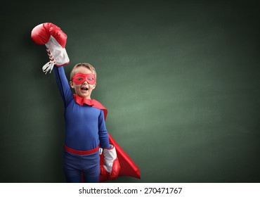 Superhero child winner with boxing gloves concept for winning, childhood, imagination, aspirations and strength