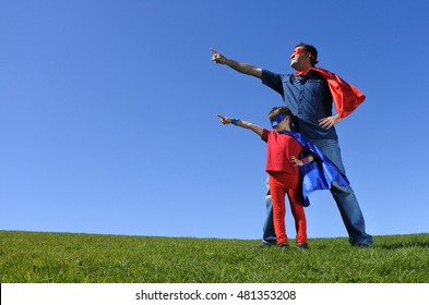 Superhero Father Showing His Young Daughter How To Be A Superhero Outdoors. Concept Photo Of Superman, Super Hero,superhero, Childhood,  Fatherhood, Parenthood, Healthy. Real People. Copy Space