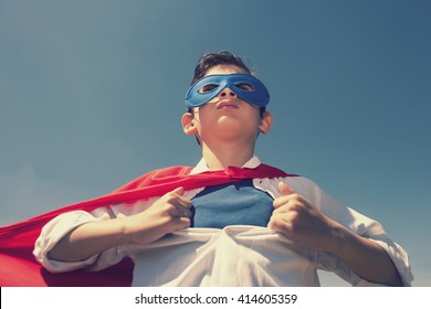 Superhero kid concept. Retro toned image with selective focus