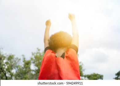 Superhero Leader Kid Raising Two Hands Up In The Sky - Success And Winning Achievement Concept