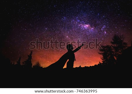superhero at the night starry sky background. Mixed media