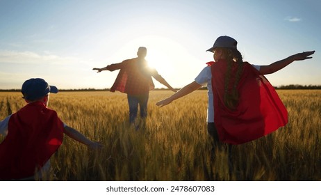 Superhero running through the wheat with his family. Child group superhero family concept. group of children are running together in a field. Superheroes run field of fun wheat children together. - Powered by Shutterstock