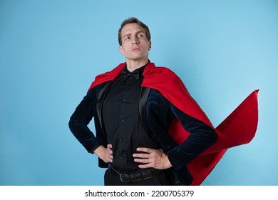 superhero stands in a heroic pose, a man in a business suit and a red cape. charismatic and successful business hero.