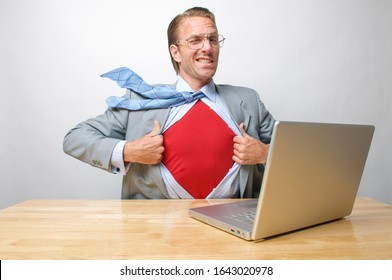 Superhero Tech Businessman Giving A Cheeky Wink To The Camera As He Gets Ready To Save The Day From His Office Desk