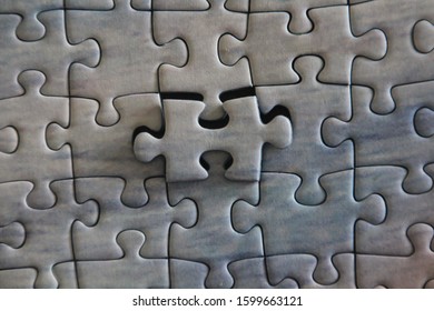 Superimposed Missing Piece Of A Jigsaw Puzzle In Focus Concept For Solutions And Completion