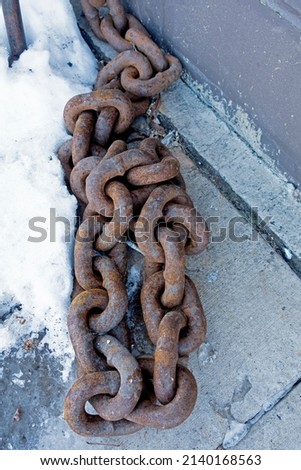 SUPERIOR, WISCONSIN USA - FEBRUARY 06, 2020: Found this rusted heavy duty anchor chain hooked to a pole outside The Anchor Bar and Grill as part of the nautical motif.