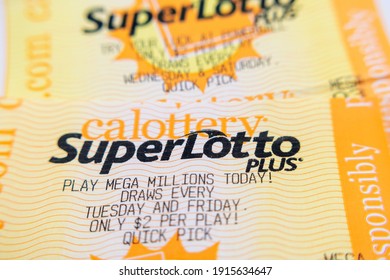 SuperLotto Plus Lottery Tickets With Mega Millions Lottery Advertisement. Selective Focus - California, USA - 2021