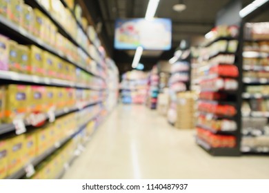 Supermarket Aisle With Baby Milk Package Product On Shelves Defocused Interior Blur Background