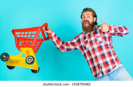 Supermarket. Bearded Man Running With Empty Shopping Cart. Buying Spree.