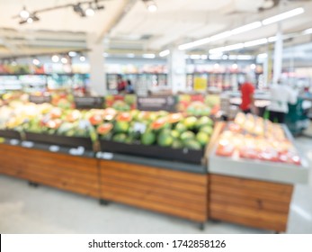 Supermarket blur background. Blurred interior view with fruit booth display in shopping mall.