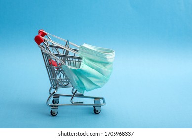 Supermarket Cart For Shopping. The Trolley Is Wearing A Medical Mask. Coronavirus Control Concept. Creative Idea For An Online Pharmacy, Online Drug Sale.