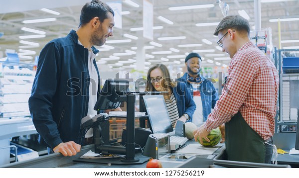 At\
the Supermarket: Checkout Counter Professional Cashier Scans\
Groceries and Food Items. Clean Modern Shopping\
Mall.