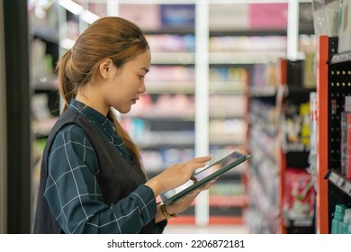 supermarket clerk using apps on a digital tablet, innovative technology and work concept, a young female supervisor with tablet pc in the mall. - Powered by Shutterstock