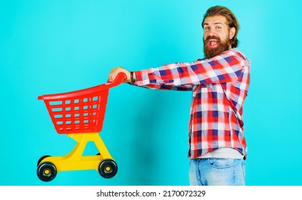 Supermarket. Happy Bearded Man With Empty Shopping Cart Or Trolley. Grocery Store. Buying Spree.