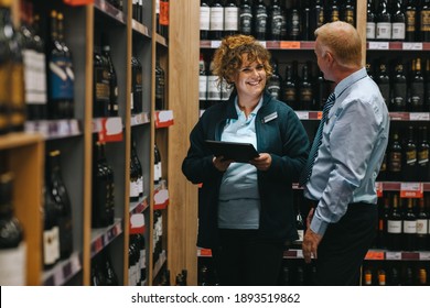 Supermarket Manager Discussing With Connoisseur. Two People Working In A Winery Store.