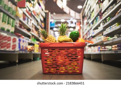 Supermarket, Market Or Grocery Store Aisle With Basket Of Quality Choice, Healthy Fruits And Vegetables. Buying Retail Sale Items In A Shopping Cart. Group Of Consumables Or Food Products On Floor